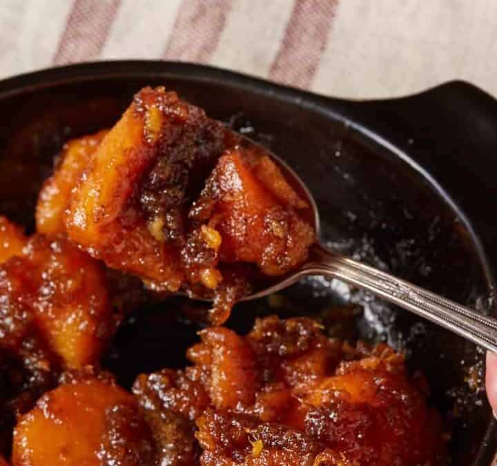 A spoon full of brown sugar sweet potatoes.