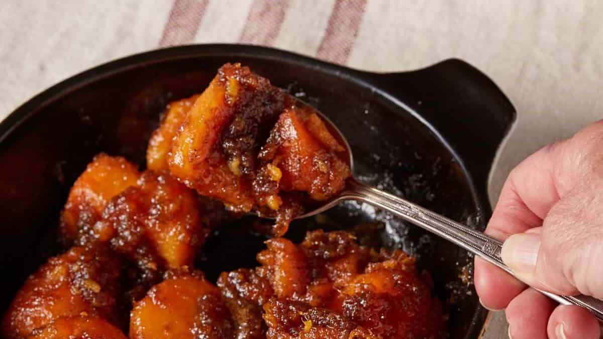 A spoon full of brown sugar sweet potatoes.