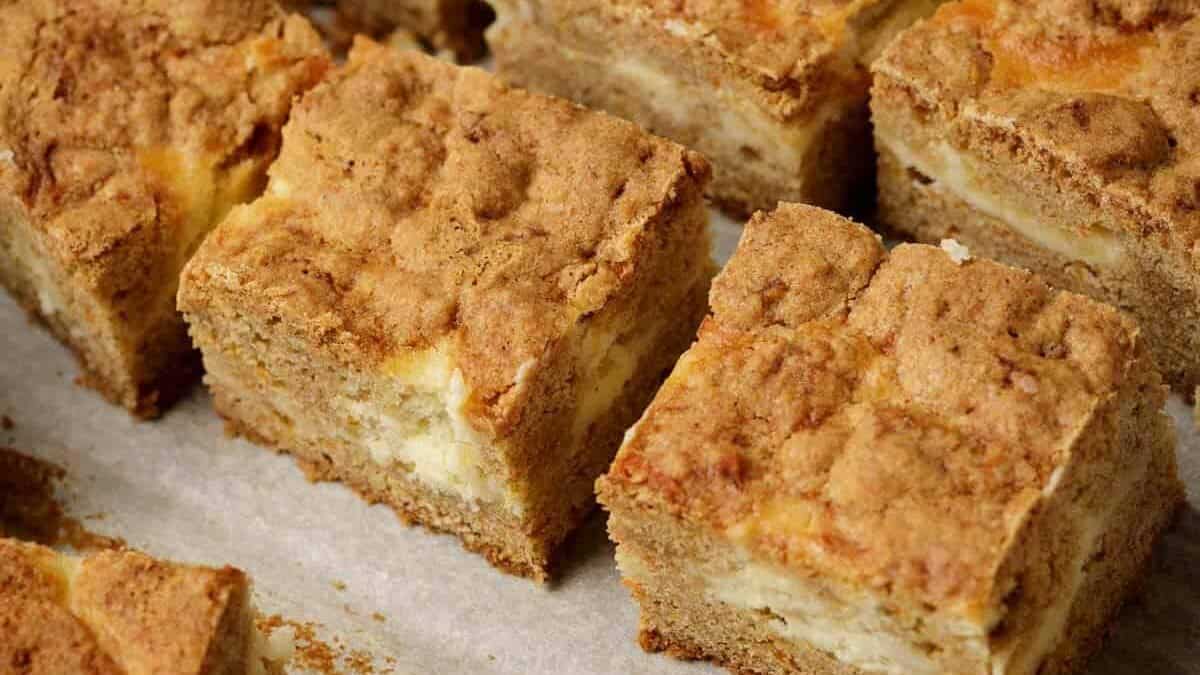 Cheesecake bars layered with moist carrot cake.