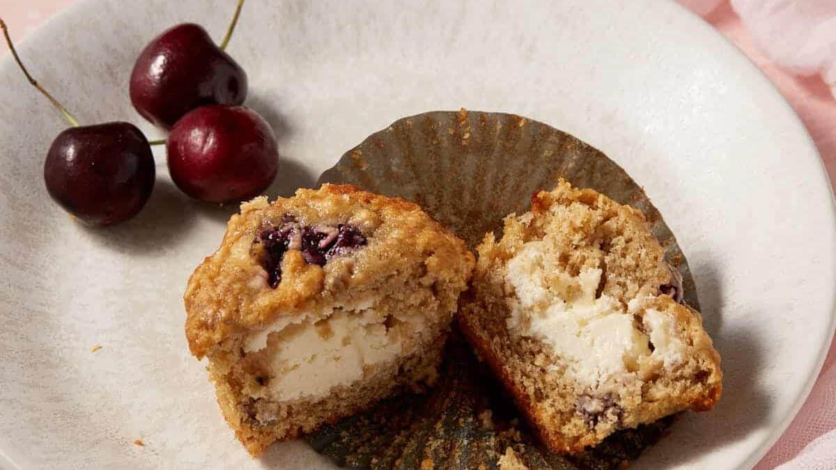 A cherry muffin, split open on a plate.