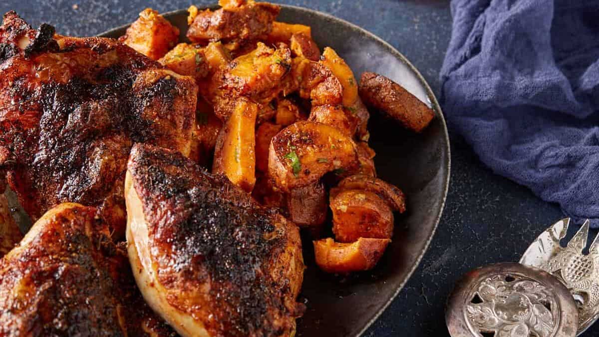 A platter of sweet potatoes and chicken.
