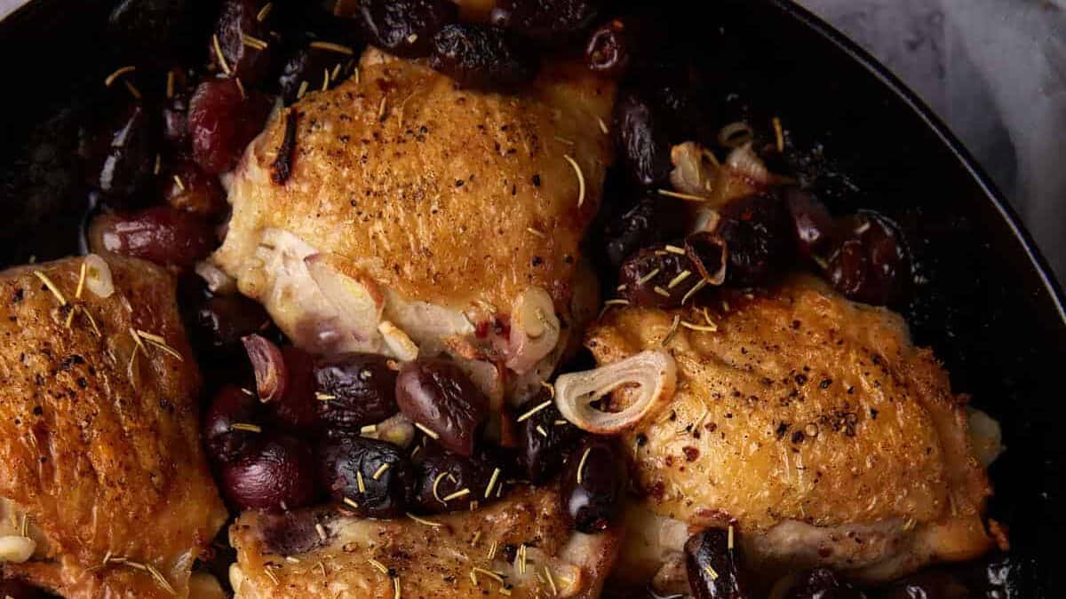 Roasted chicken thighs in a skillet.