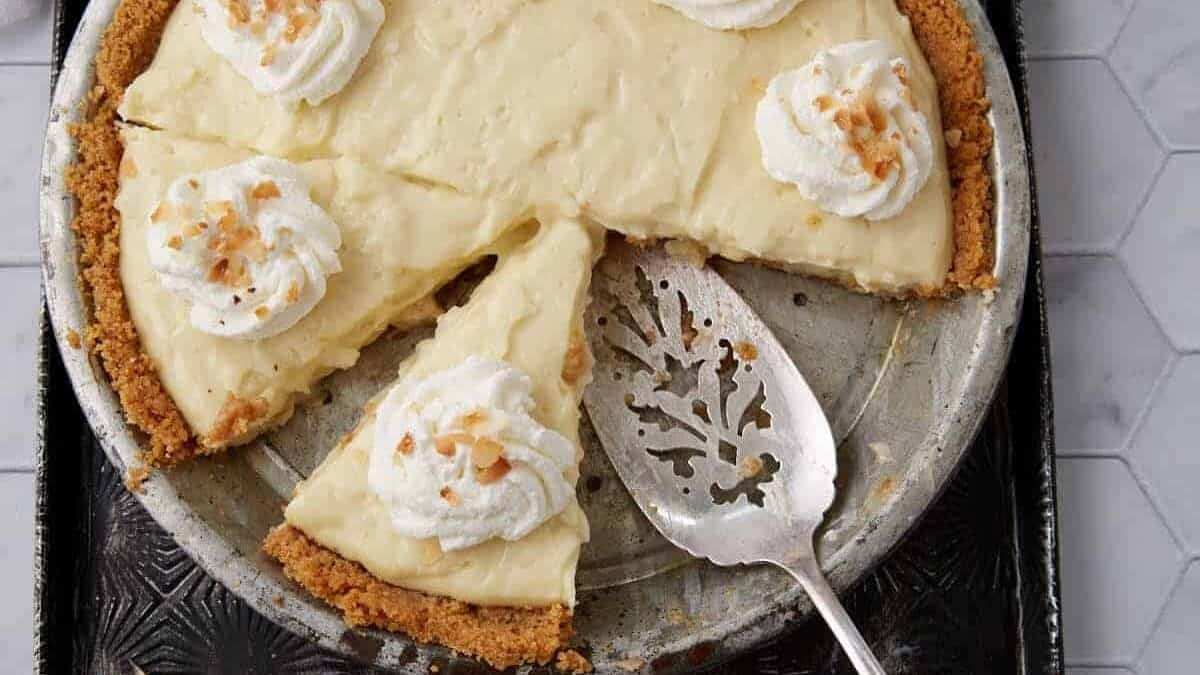 Coconut Cream Pie with a pie server.