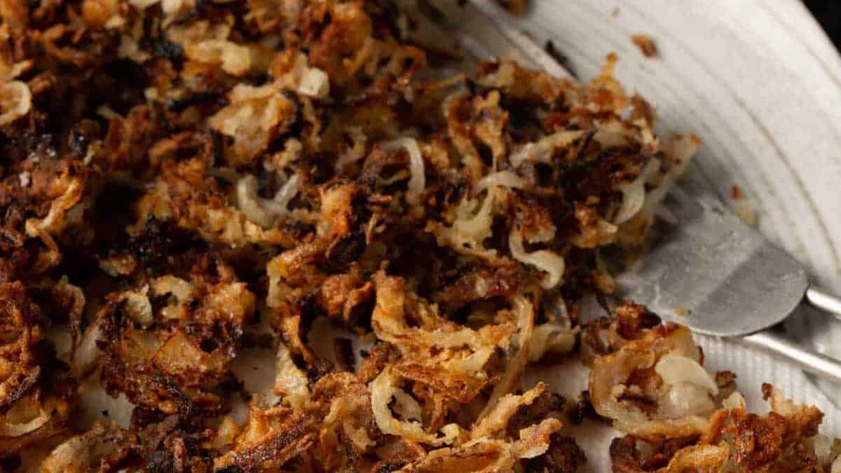 Golden onions on a white platter.