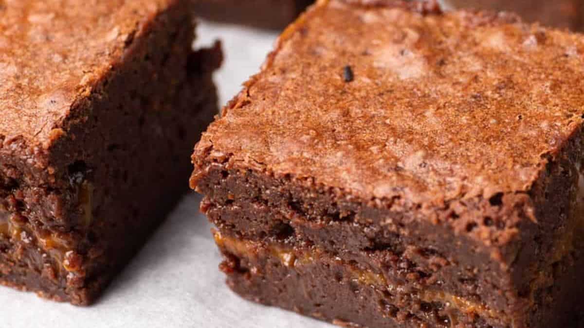 brownies with a layer of dulce de leche on parchment paper