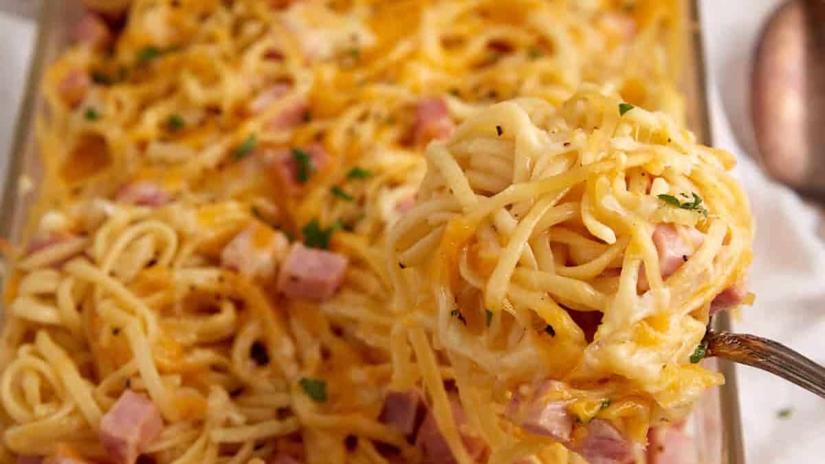 A serving of ham and cheese casserole in a spoon.