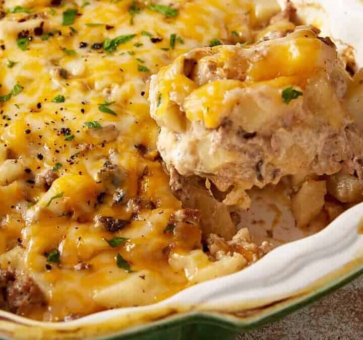 A spoon full of hamburger potato casserole.