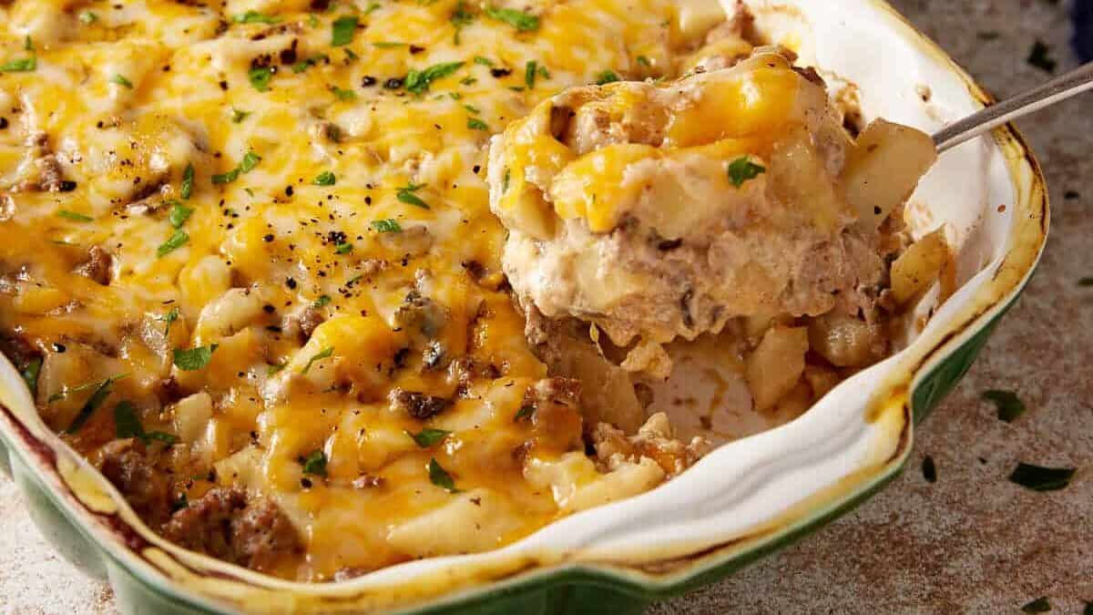 A spoon full of hamburger potato casserole.