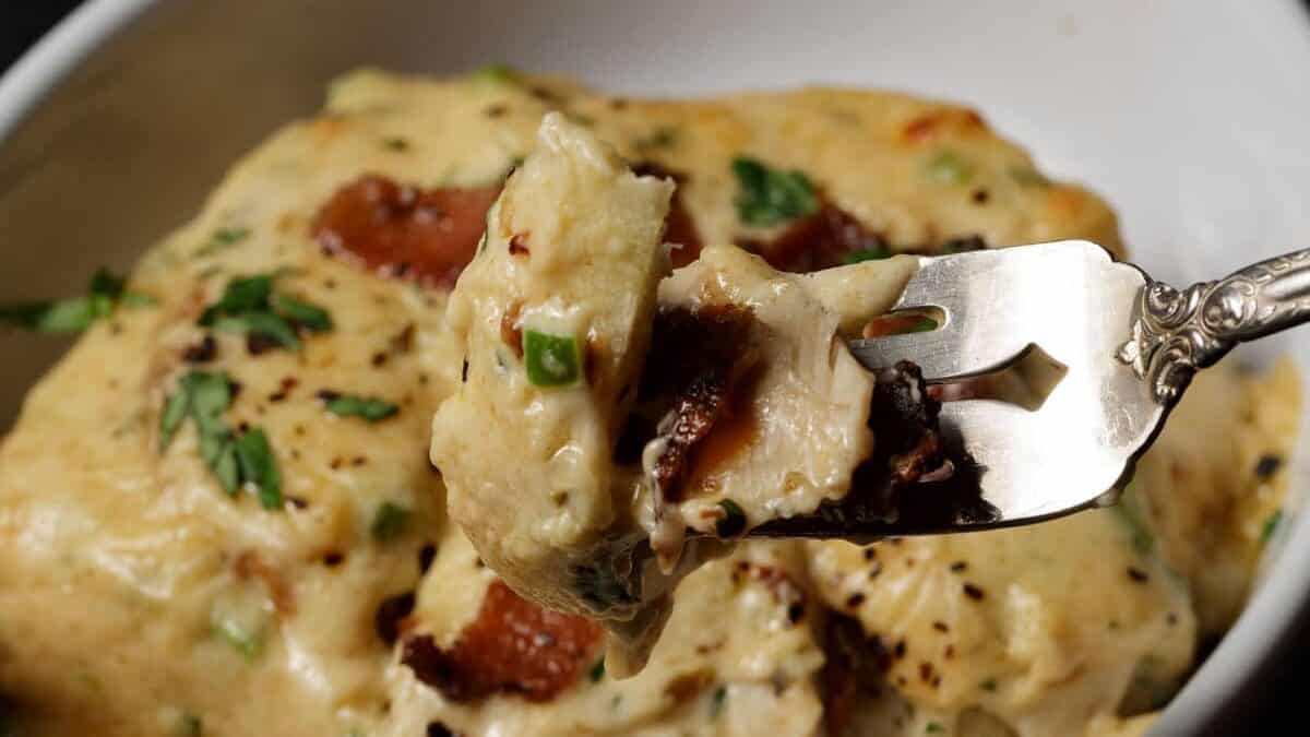 A bite of a Kentucky hot brown on a fork.