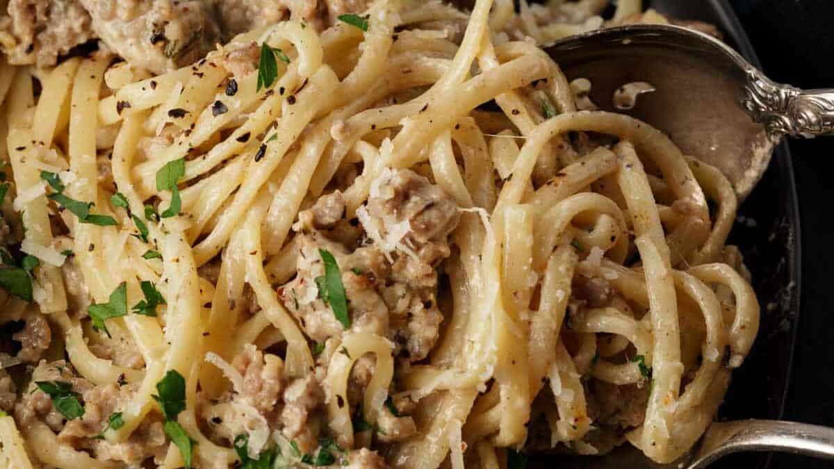 Creamy pasta with Italian sausage on a platter