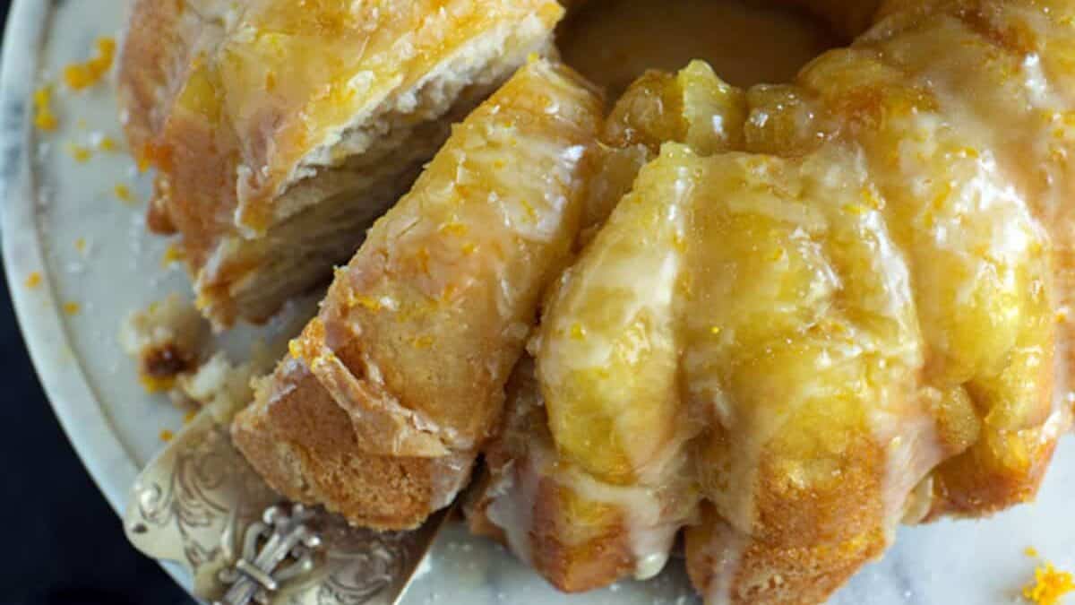 A single slice of monkey bread being removed from the bundt cake.
