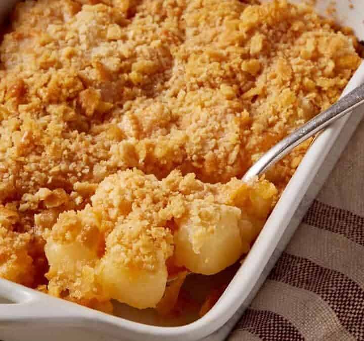 A spoon full of pineapple cheese casserole.