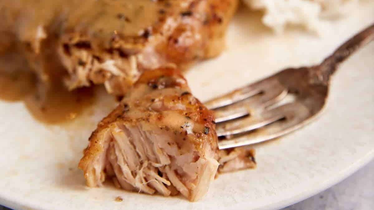 A bite of ranch pork chops on a fork.