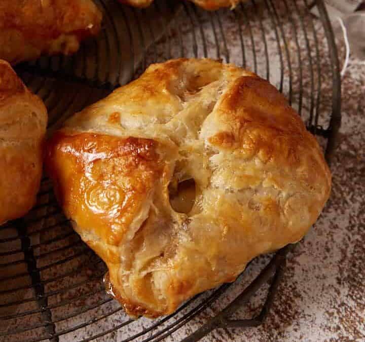 Puff pastry pockets next to mugs and tea bags.