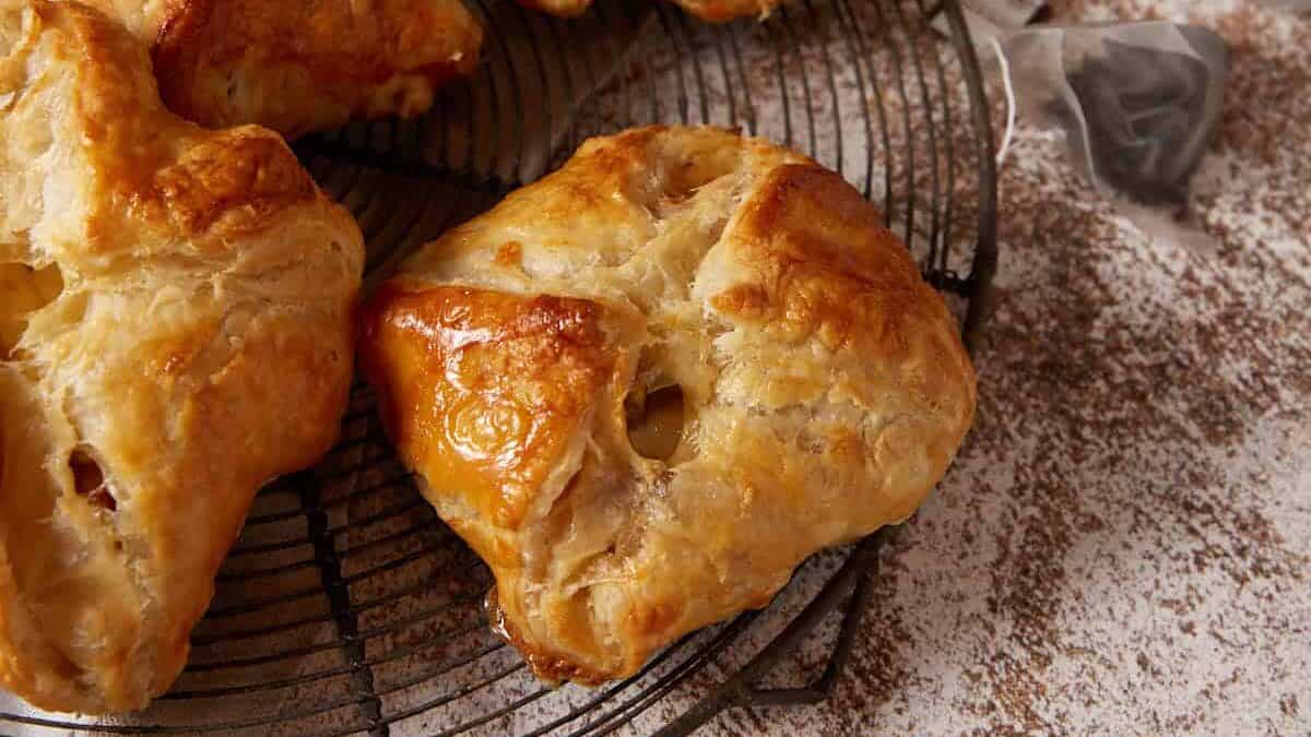 Puff pastry pockets next to mugs and tea bags.
