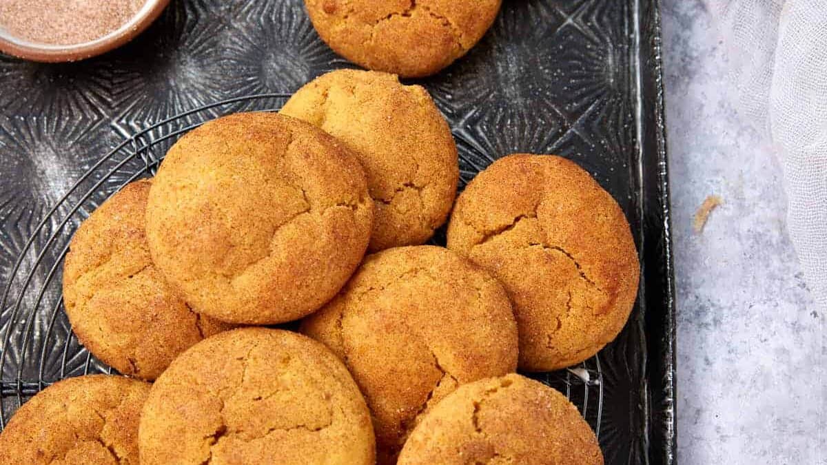 A tray stacked with pumpkin snickerdoodle cookies.