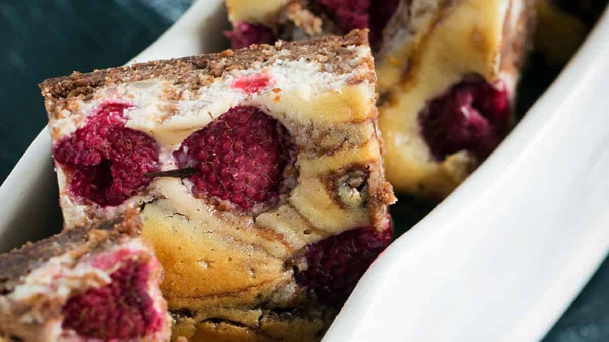 A white dish layered with raspberry brownies.