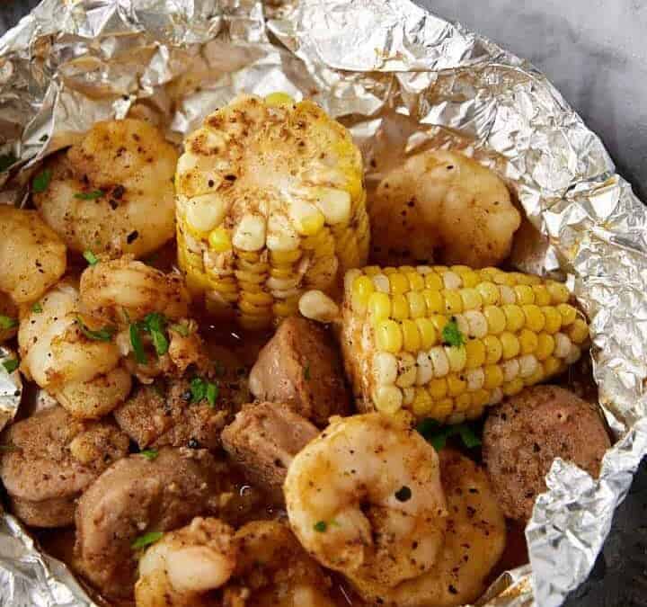 Two shrimp boil packs with toasted bread.