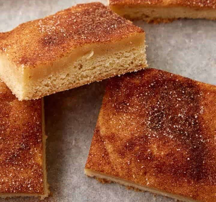 A batch of snickerdoodle bars on parchment paper.