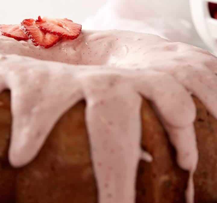 A frosted strawberry bundt cake.