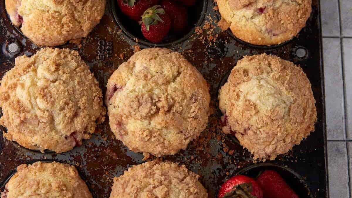 A muffin tin full of strawberry muffins.