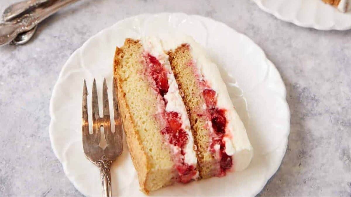 A slice of strawberry shortcake with frosting.