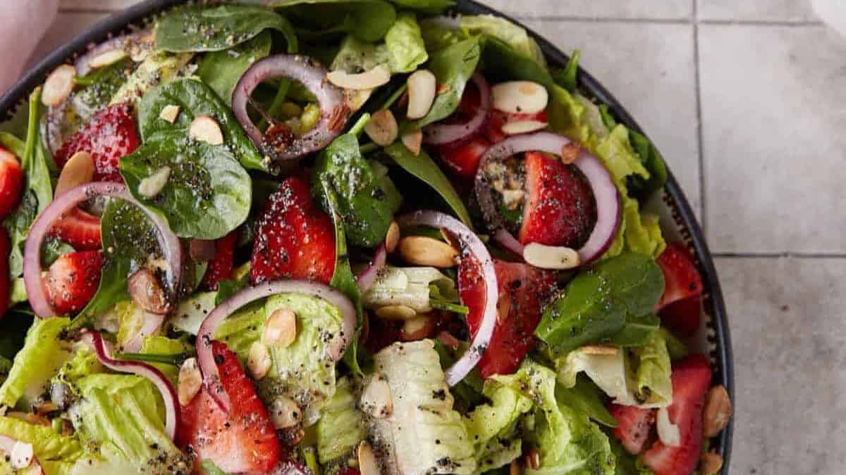 A bowl of strawberry spinach salad.