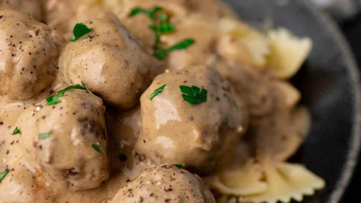A platter of Swedish meatballs over pasta.