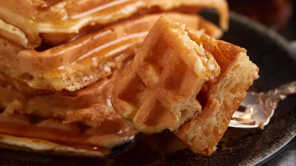 A bite of waffle on a fork.