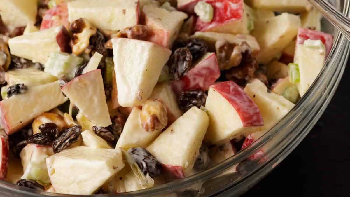 A bowl of waldorf apple salad in a glass bowl