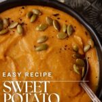 A bowl of sweet potato soup with a spoon.