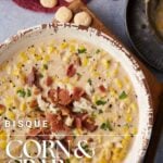 A bowl of corn and crab bisque with oyster crackers.