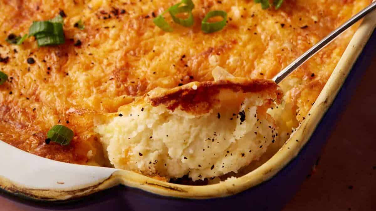 A spoon full of twice baked mashed potatoes.