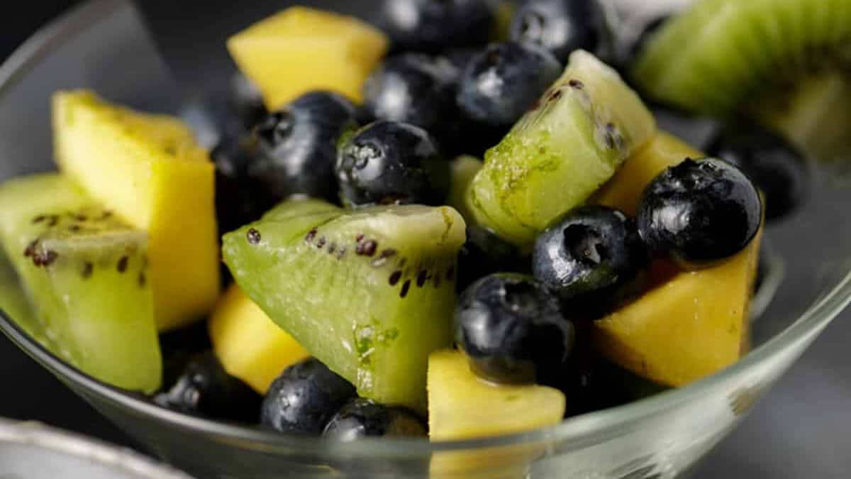 Blueberry Salad with mangos and kiwi in a martini glass.