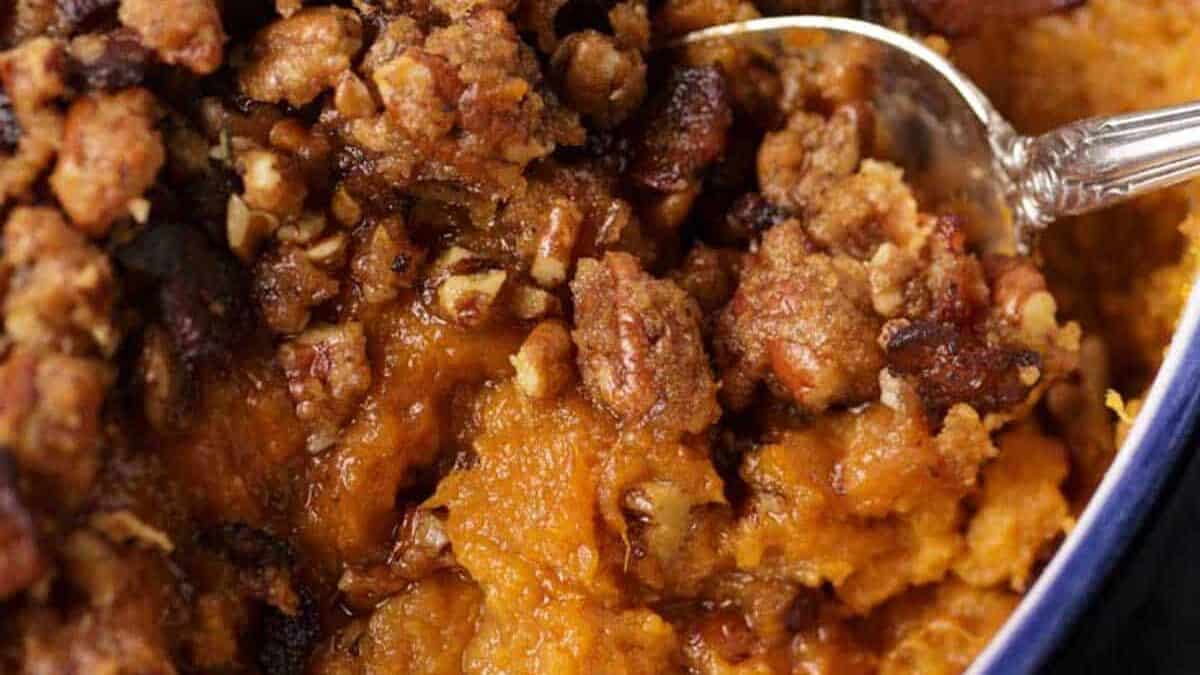 Sweet potato casserole with a serving spoon.