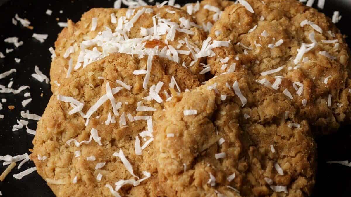 Coconut falling onto brown butter cookies