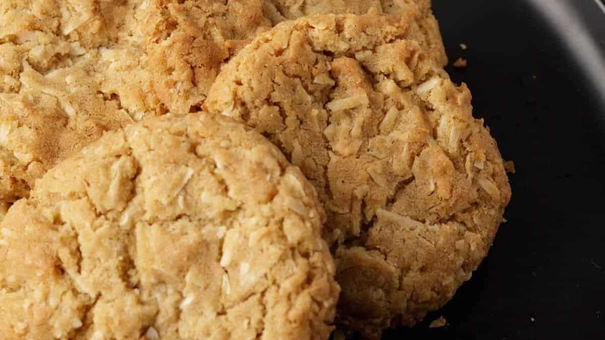 A plate of coconut brown butter cookies with a plate of milk