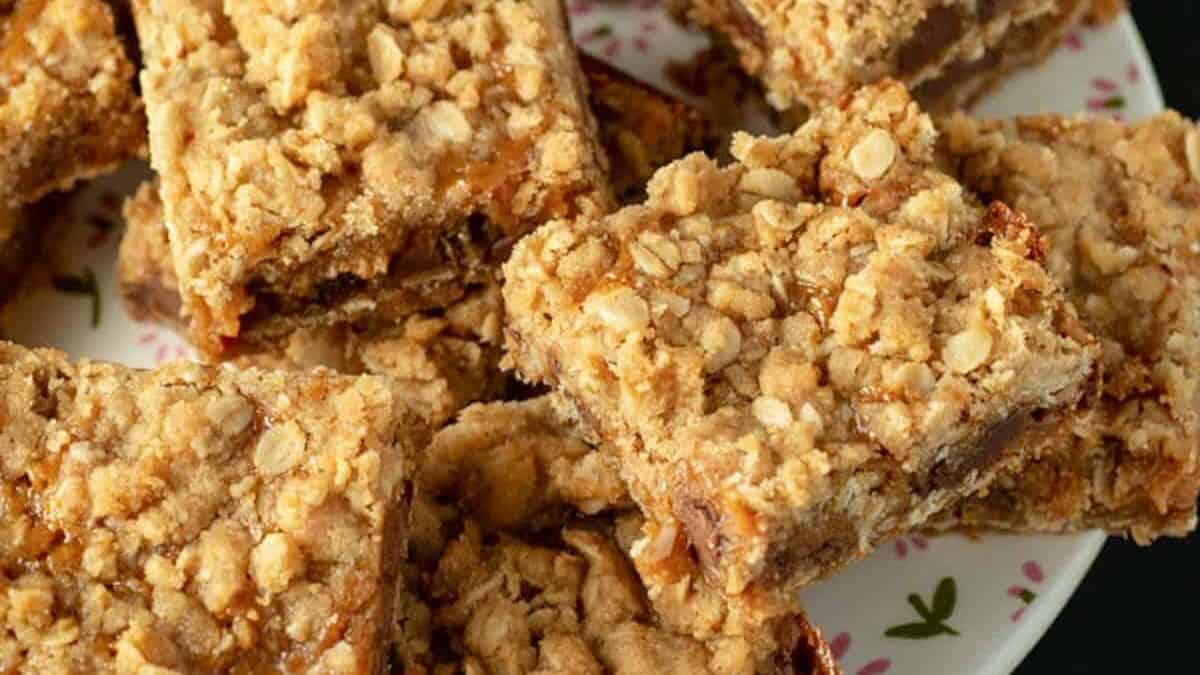 Carmelitas stacked on a cake platter.