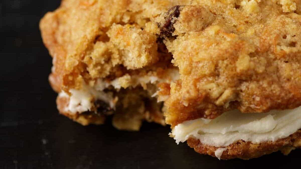 A bite taken out of a carrot cake cookie