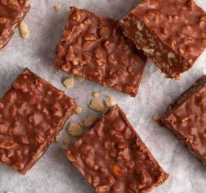 A pan of chocolate rice krispie squares on parchment paper.