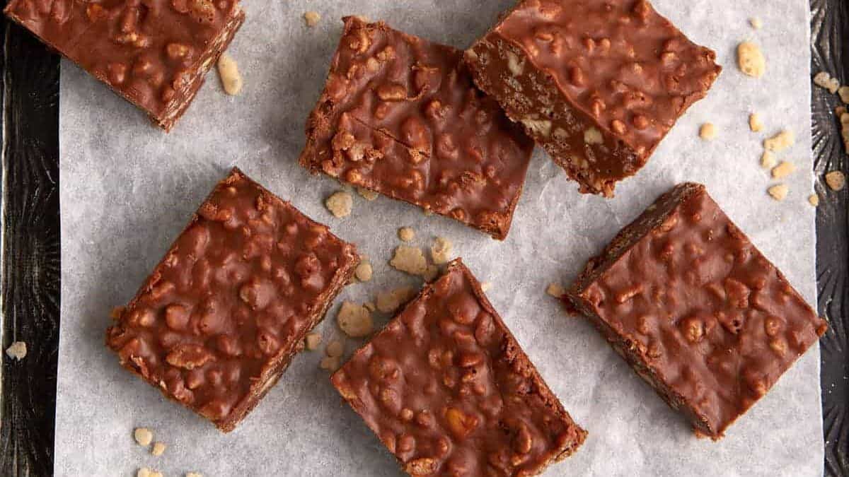 A pan of chocolate rice krispie squares on parchment paper.