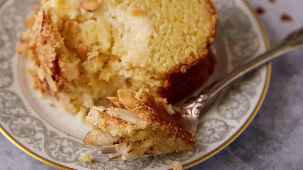 A single slice of cream cheese coffee cake with a fork.