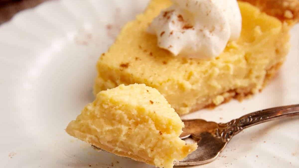 A bite of eggnog pie on a fork.