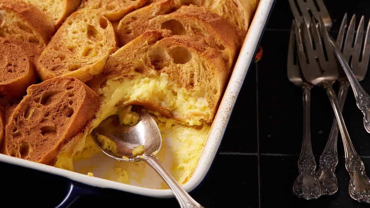 An eggnog overnight casserole next to coffee cups.