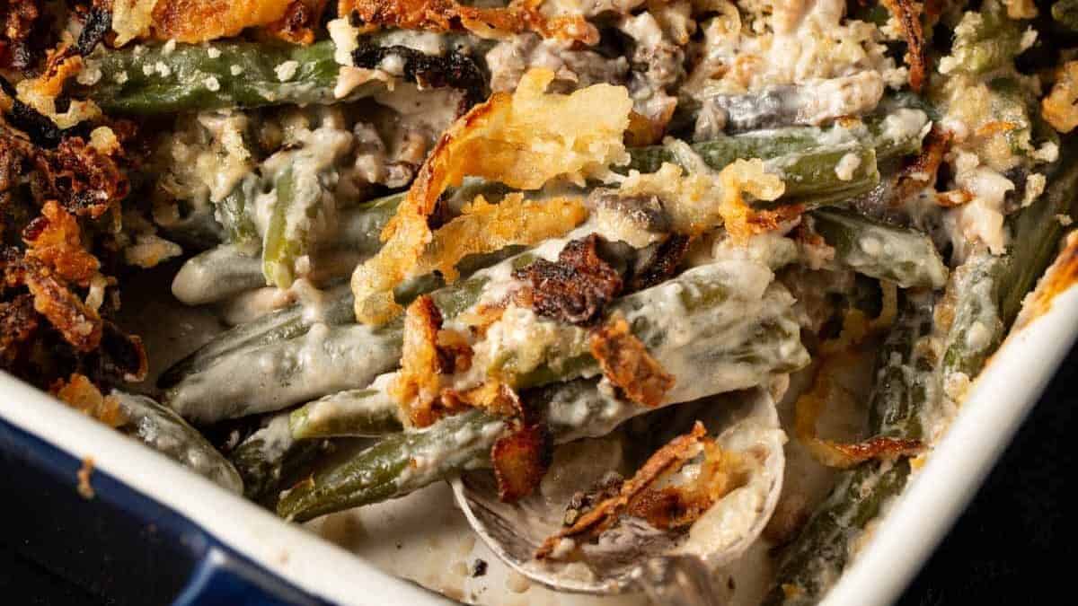 A serving spoon in a green bean casserole made from scratch,