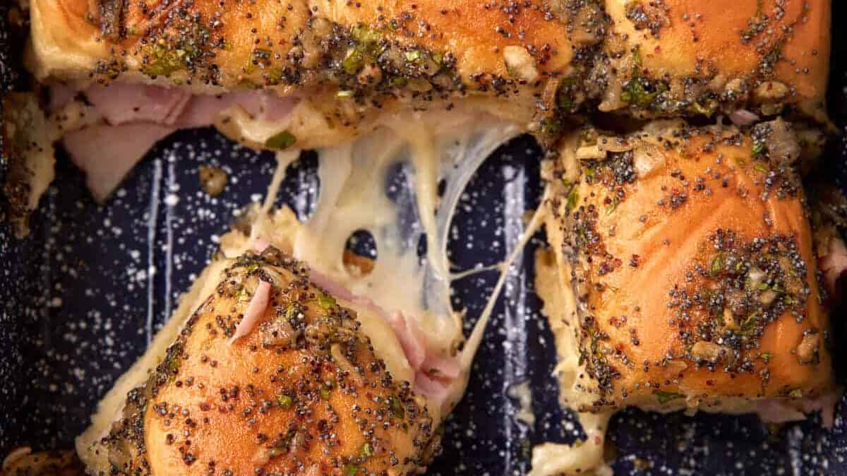 Ham and Swiss sliders baked with golden tops.