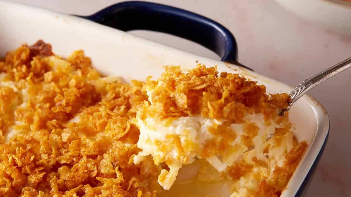 A spoon full of hashbrown casserole.