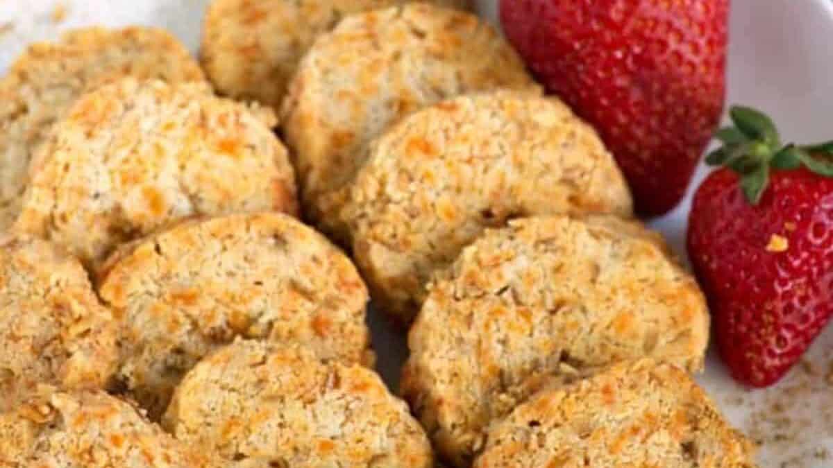 A platter of old bay cheese wafers with some strawberries.