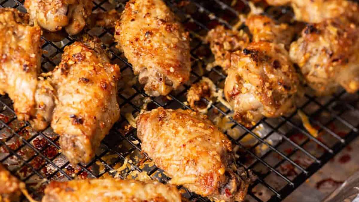 Parmesan chicken wings on a cooling rack.