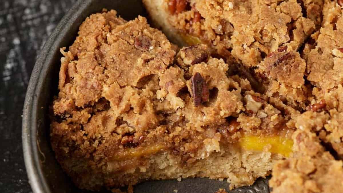 A cake pan of baked peach coffee cake.